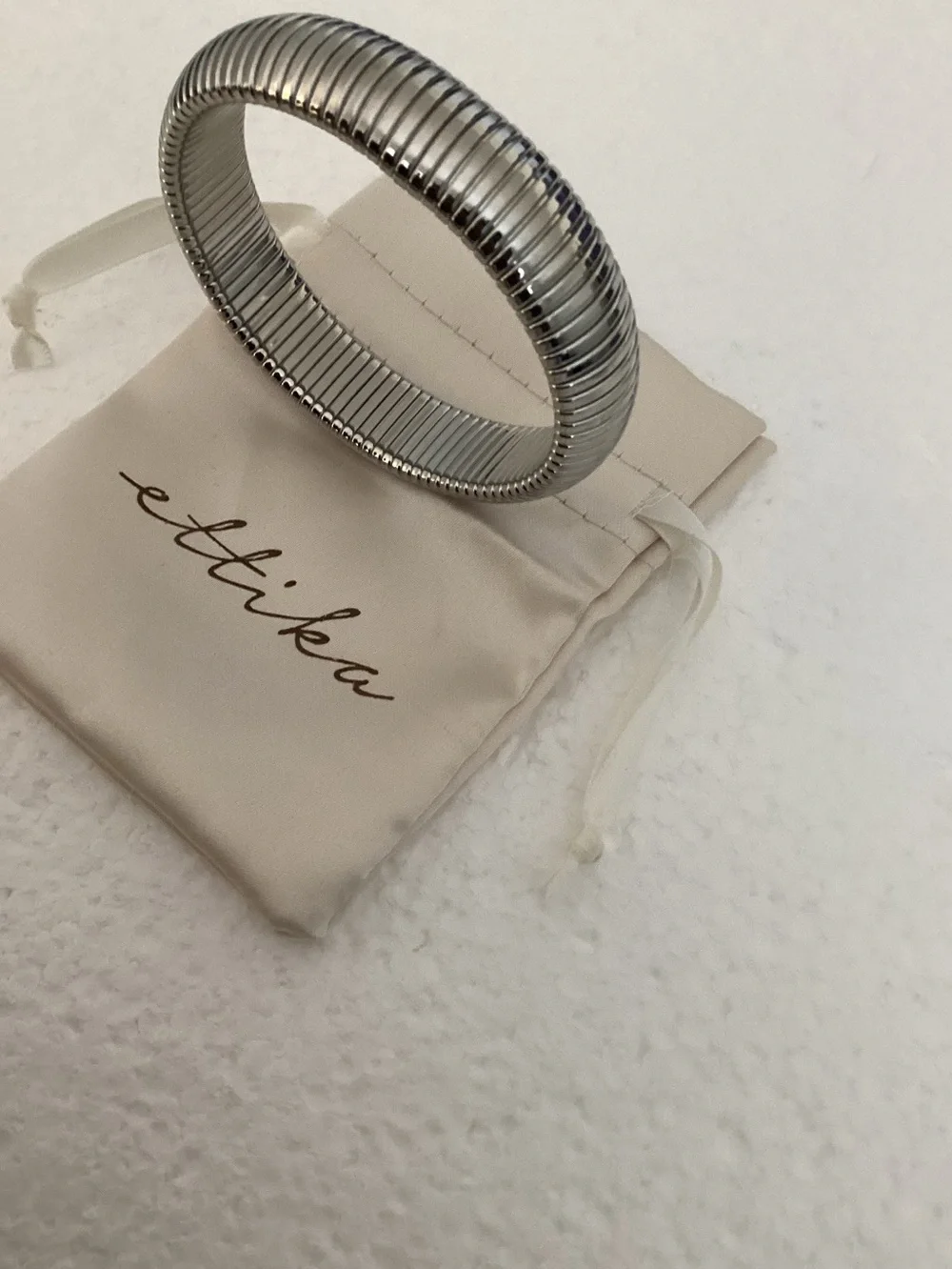 This Ettika silver-plated flexible tubogas-style stretch cuff silver tone brace